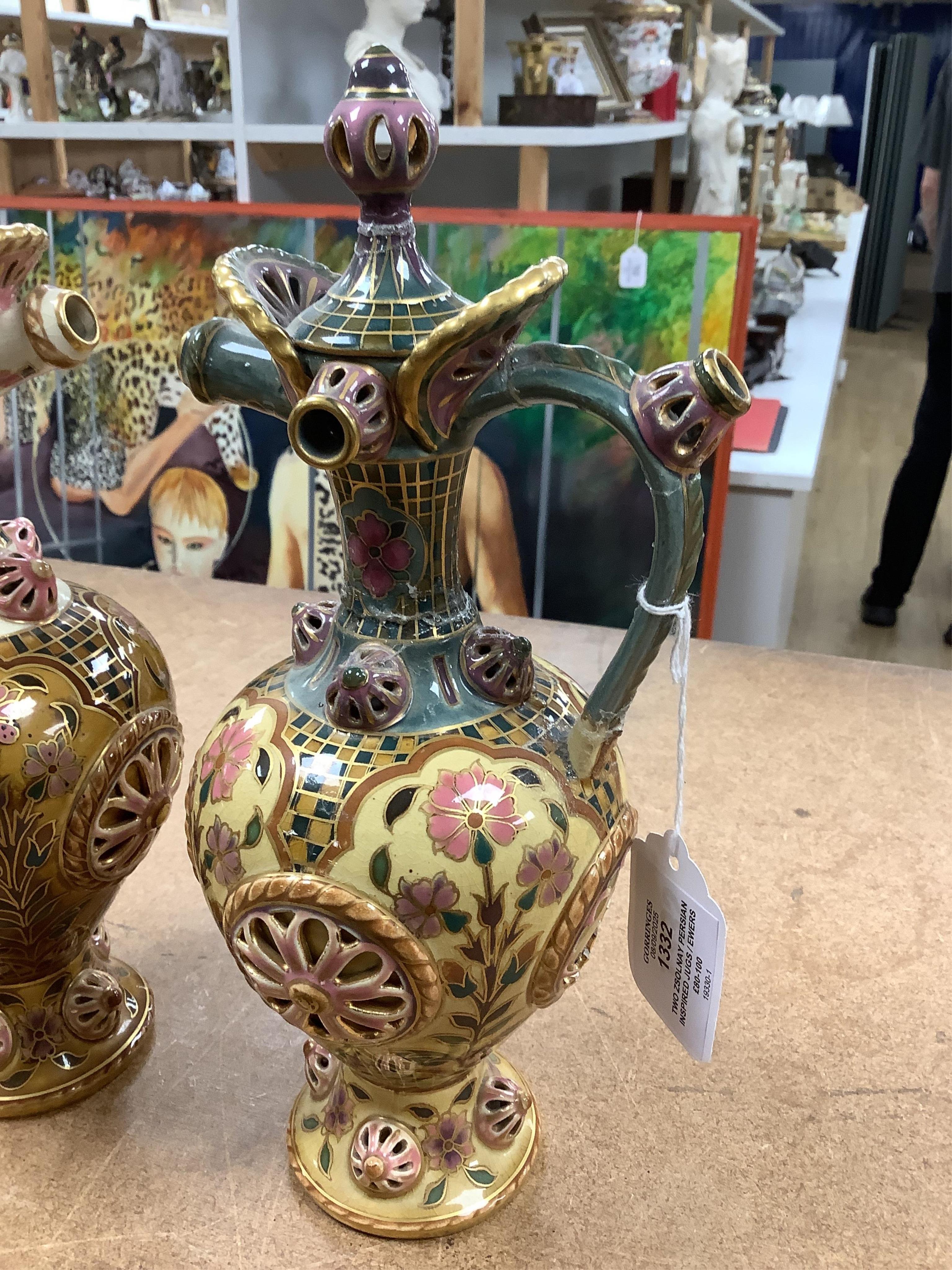 Two Zsolnay Persian inspired jugs / ewers and covers, stamped to the bases 29cm high